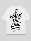 Achterkant van het witte I WALK THE LINE T-shirt van FAKESNIFF, met een geschilderde tekst I WALK THE LINE met daaronder 'you too?' in schuinschrift